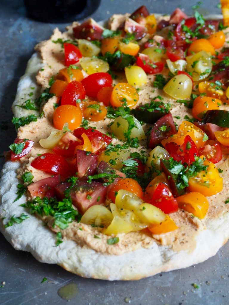 Bruschetta med hummus og tomater på pizzabunn